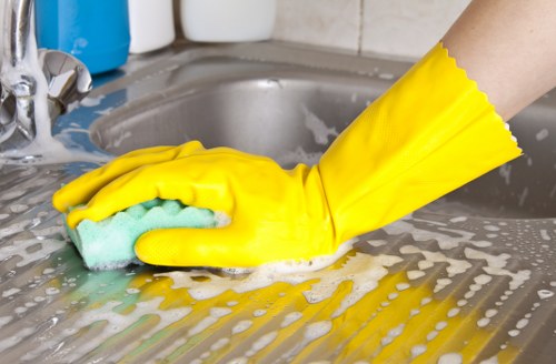 Local cleaners disinfecting desks and touchpoints in a Canary Wharf office interior